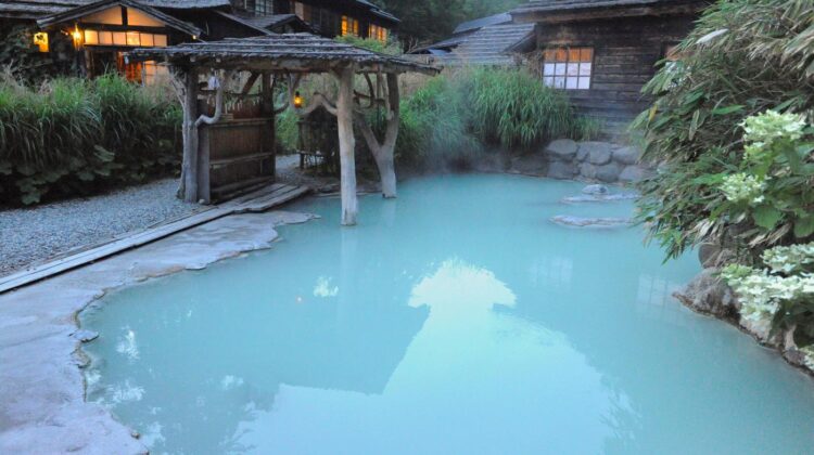 The mixed-bathing outdoor bath at Tsuru no Yu inn in Nyuto Onsen hamlet in the evening